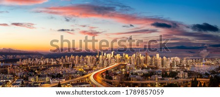Aerial Panoramic view of Downtown Vancouver, Cambie Bridge, and False Creek. Picture taken during a cloudy sunset. Colorful sky Overlay.