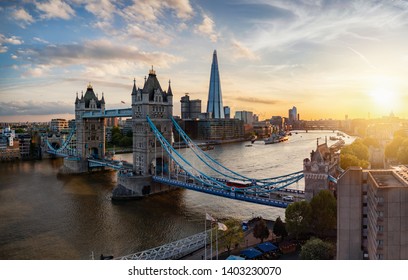 Aerial panoramic view to the iconic Tower Bridge and skyline of London, UK, during sunset time
