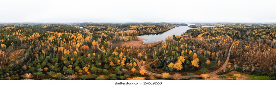 Aerial panoramic view of lake and colorful forests on a autumn day in Finland. Drone photography