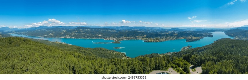 Aerial panoramic view of Lake Wörthersee seen from Pyramindenkogel in Carinthia, Austria. Serene turquoise waters, lush green forests and rolling hills of Austrian Alps. Charming lakeside village - Powered by Shutterstock