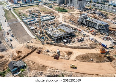aerial panoramic view of large construction site at sunny summer day. construction of new buildings and urban road.