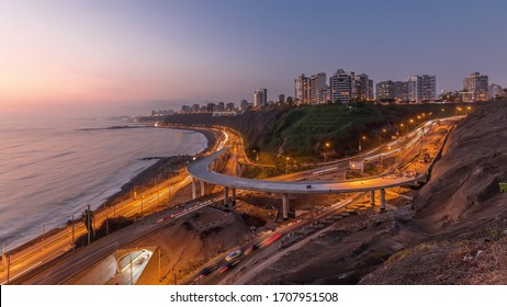 Aerial Panoramic View Of Lima's Coastline In The Neighborhood Of Miraflores Day To Night Transition Timelapse, Lima, Peru. Road Traffic With Junction And Beach With Ocean From Husares De Junin