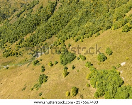 Aerial panoramic view of medieval stone houses in traditional village, Halde valley and glacier in the Greater Caucasus Mountain Range, Samegrelo-Upper Svaneti region in Georgia.