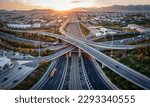 Aerial panoramic view of multilevel junction highway road as seen in Attiki Odos toll road motorway, Athens, Greece, during golden sunset time