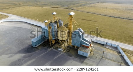 aerial panoramic view on agro-industrial complex with silos and grain drying line for drying cleaning and storage of agricultural products