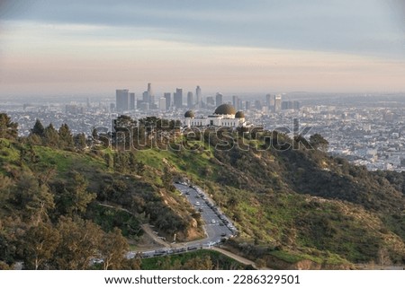 Aerial panoramic view over Griffith Park, the Hollywood Hills and downtown Los Angeles