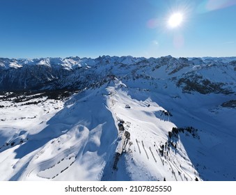 Aerial panoramic view over the snowy mountains in Tirol Alps. The top station of cableway (Vorarlberg, Austria).
