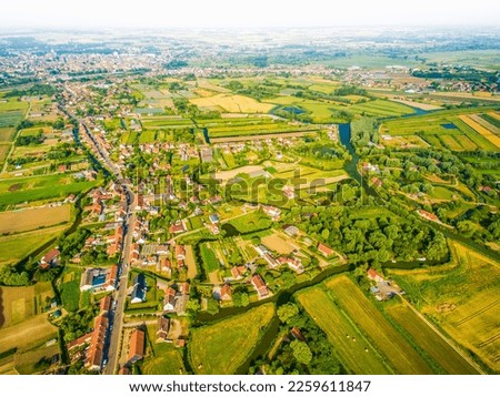 Aerial panoramic view over Westport and Irish green countryside by river in spring