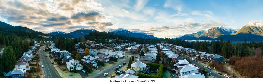 Aerial Panoramic View Of Residential Homes In A Touristic City. Colorful Sunrise Sky. Taken In Squamish, North Of Vancouver, British Columbia, Canada.