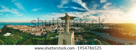 Aerial panoramic view of Sanctuary of Christ the King or Santuario de Cristo Rei at sunset. Christ Statue in Lisbon, Portugal.