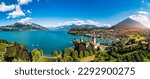 Aerial panoramic view of Spiez Church and Castle on the shore of Lake Thun in the Swiss canton of Bern at sunset, Spiez, Switzerland. Spiez Castle on lake Thun in the canton of Bern, Switzerland.