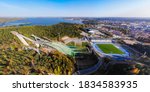 Aerial panoramic view of sports centre with three ski jump towers in Lahti, Finland