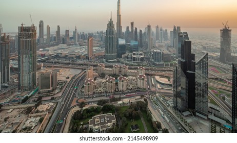 Aerial panoramic view of tallest towers in Dubai Downtown skyline and highway day to night transition. Financial district and business area in smart urban city. Skyscraper and high-rise buildings