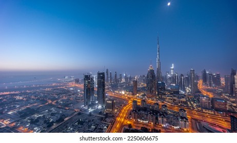 Aerial panoramic view of tallest towers in Dubai Downtown skyline night to day transition  before sunrise. Financial district and business area in smart urban city. Skyscraper and high-rise buildings - Powered by Shutterstock