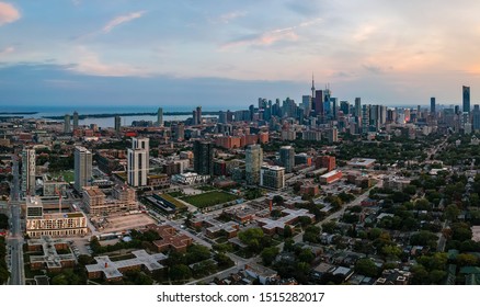 Aerial Panoramic View Of Toronto City Skyline With Streets, Roads, Infrastructure, Residential Areas And Parks At Dusk. Shot With Drone. 