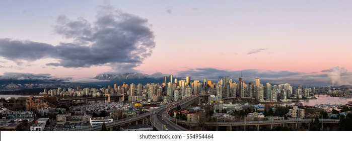Aerial Panoramic View Of Vancouver Downtown City Skyline, In BC, Canada. Taken During A Beautiful Cloudy Winter Sunset.