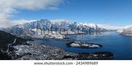 Aerial panoramic winter view of Queenstown, Lake Wakatipu and the Remarkables mountain range in the Southern Alps on New Zealand's South Island