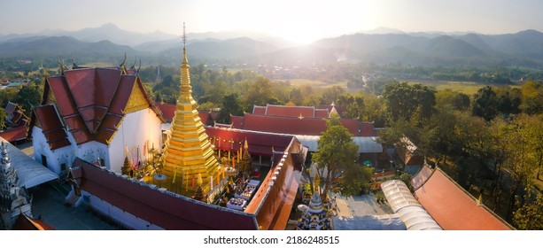 Aerial paranomic view of beautiful golden pagoda in Wat Phra That Cho Hae with nature landscape backgroung at Phrae, Thailand.