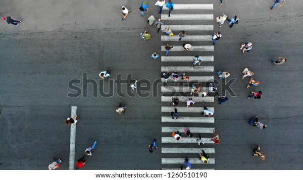 Aerial. Pedestrian crossing crosswalk and crowd of\
peolple. 