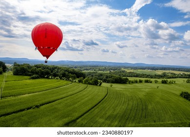 Aerial of Pennsylvania farmland with rows of crops and red hot air balloon - Powered by Shutterstock