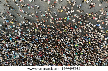 Aerial. People crowd on a city square background. Top view.