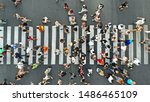 Aerial. People crowd on pedestrian crosswalk. Top view background.