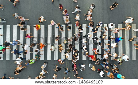 Aerial. People crowd on pedestrian crosswalk. Top view background.