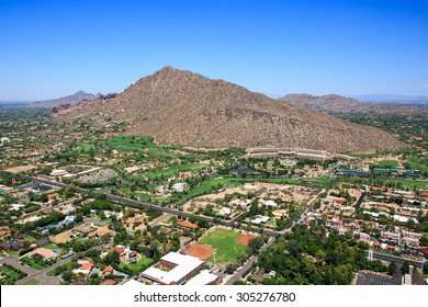Aerial perspective of exclusive homes and golf course near Camelback Mountain in Phoenix, Arizona
