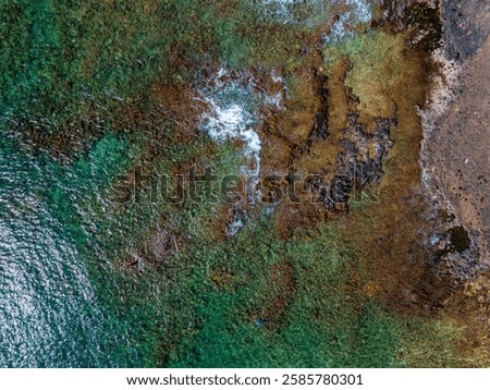 Similar – Image, Stock Photo Aerial perspective of textured desert terrain with intricate erosion patterns and trails in Utah, exhibiting a blend of golden and grey hues