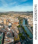 Aerial perspective of old town center of Murcia. Rooftops of Murcia. Medieval and historic travel destination in Spain. View of Cathedral of Murcia. River Segura at right. Vertical photo.