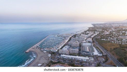 Aerial perspective of "Puerto Banus" Bay in Marbella, Spain. Luxury travel destination famous for expensive lifestyle and shopping area. Exclusive restaurants. Luxury yacht. Sunset. Beautiful sky