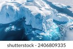 An aerial perspective showcases the dramatic melting icebergs of Antarctica, where the vivid blue sea claims the collapsing icy giants, a poignant visual testament to climate change