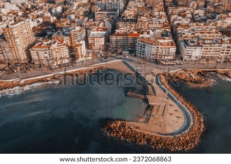 Aerial perspective of Torrevieja reveals a harmonious blend of village charm, pristine beach, and vibrant waterfront. From above, the Spanish town's diverse beauty unfolds, merging tradition with the 