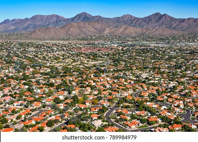 Aerial Perspective Of An Upscale Southwest Suburban Neighborhood With A Scenic Mountain Backdrop