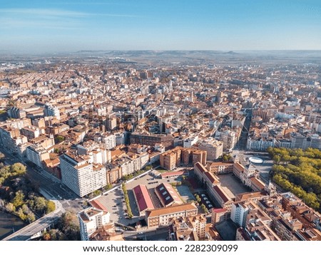Aerial perspective of Valladolid city center at sunrise. View of Plaza Mayor and Cathedral of Valladolid. Sun in the right corner of the camera. Beautiful panoramic view of the city. 