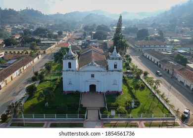 Aerial photo of an antique cathedral that is illuminated by a nice sunrise light