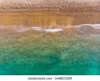 Aerial photo of the beautiful Brighton beach, located in the south coast of England UK that is part of the City of Brighton and Hove, taken on a bright sunny day  showing the ocean and beach.
