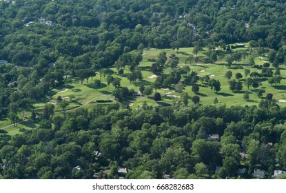 Aerial Photo Of Beautiful Green Golf Course In Suburban Area On Bright Summer Weather Day Surrounded By Trees And East Coast Suburban Neighborhood