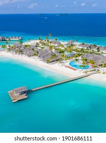 Aerial photo of beautiful Maldives paradise tropical beach. Amazing view, blue turquoise lagoon water, palm trees and white sandy beach. Luxury travel vacation destination. Sunny aerial landscape