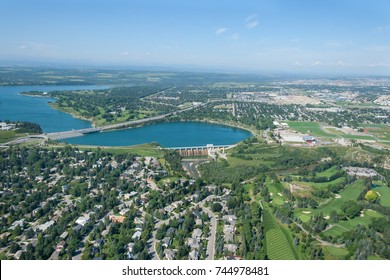 Aerial Photo Of A City And Man Made Reservoir During Summer. Glenmore Reservoir, Calgary, Alberta, Canada.