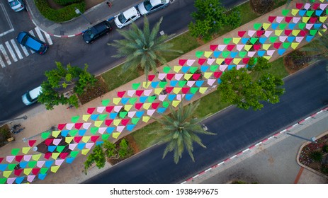 Aerial photo of the city of Tel Aviv Yafo in Israel. Taken from deep inland the photo shows the city from above Ben Gurion Boulevard decorated with colorful array of kites next to Gan Haiir park