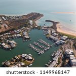 An aerial photo of Cullen Bay, Darwin, Northern Territory, Australia showing marina, residential area and rock wall