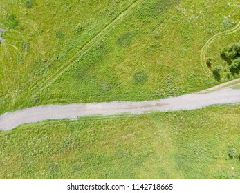 Aerial photo of the dirt road in a countryside field