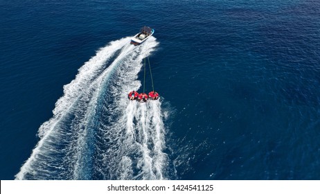 Aerial photo of extreme power boat donut water-sports cruising in high speed in deep blue open ocean bay