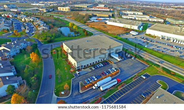 Aerial\
photo of the Fall colors over a warehouse facility near Waukegan\
Illinois with trucks arriving at the loading\
docks