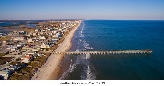 Aerial Photo Of A Fishing Pier Stretching Out Over The Atlantic Ocean.