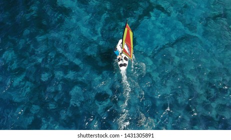 Aerial Photo Of Fit Woman Practising Wind Surfing In Tropical Exotic Turquoise Bay With Natural Clear Sea