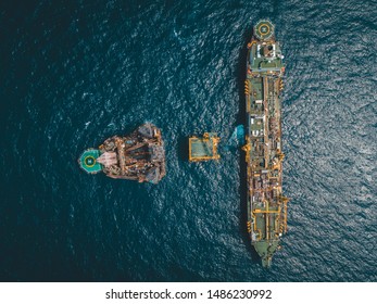 Aerial Photo Of Floating Storage Unit, A Wellhead Platform And Drilling Rig At Oil Field.