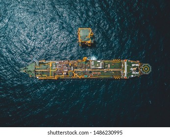 Aerial Photo Of Floating Storage Unit, A Wellhead Platform And Drilling Rig At Oil Field.