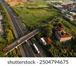 Aerial photo of a flyover passing over a toll road in the city of Gresik